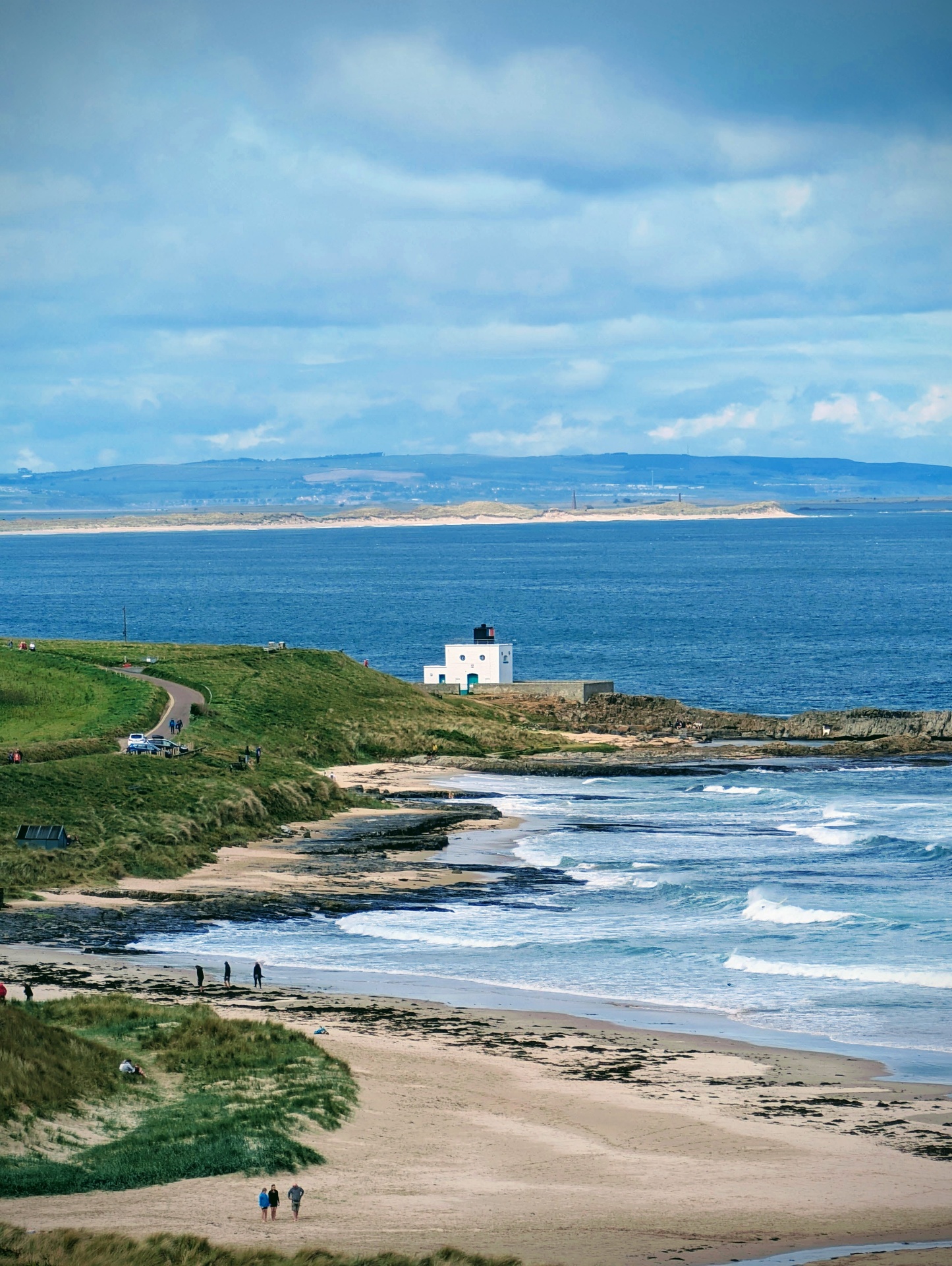 Sweeping Northumberland coastline with sandy beach, headland and sea